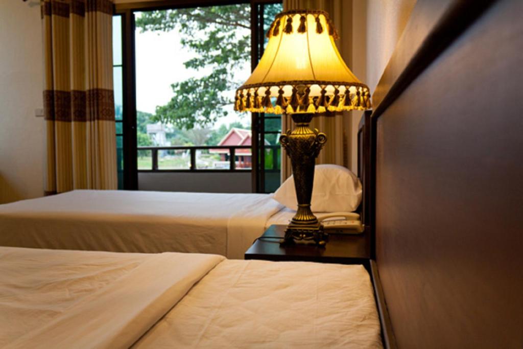 Postel nebo postele na pokoji v ubytování Kong Garden View Resort Chiang Rai