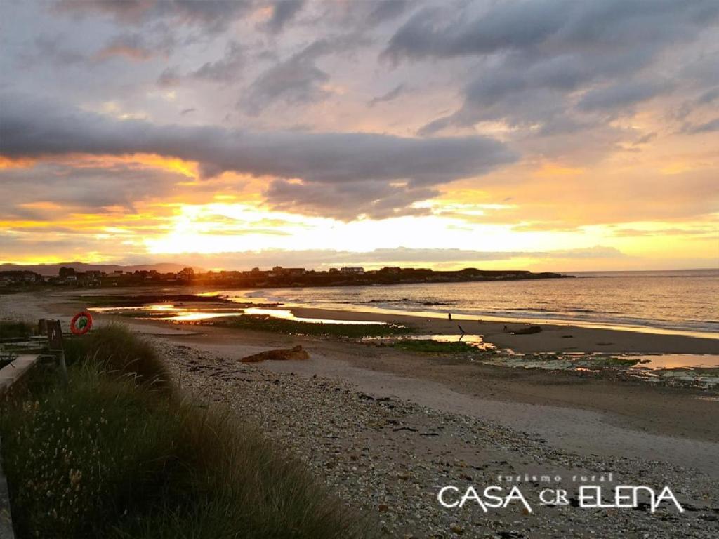 a sunset on a beach with the ocean at Casa Elena Turismo Rural in Reinante
