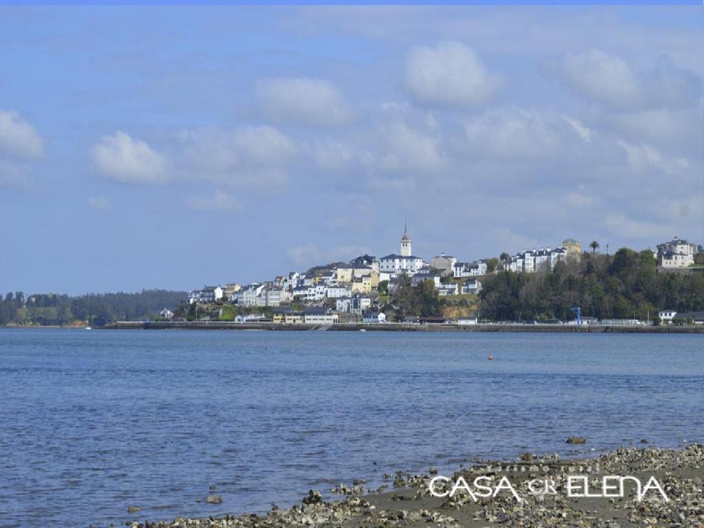 a large body of water with buildings in the background at Casa Elena Turismo Rural in Reinante