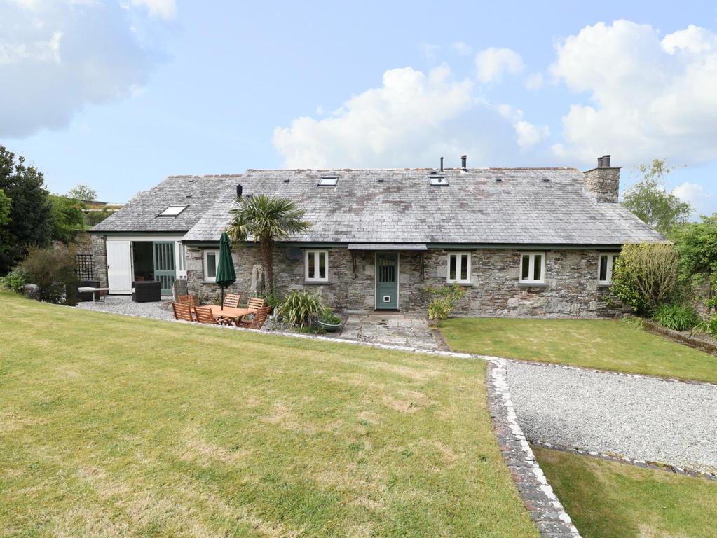 an old stone house with a large yard at The Groom's House in Callington