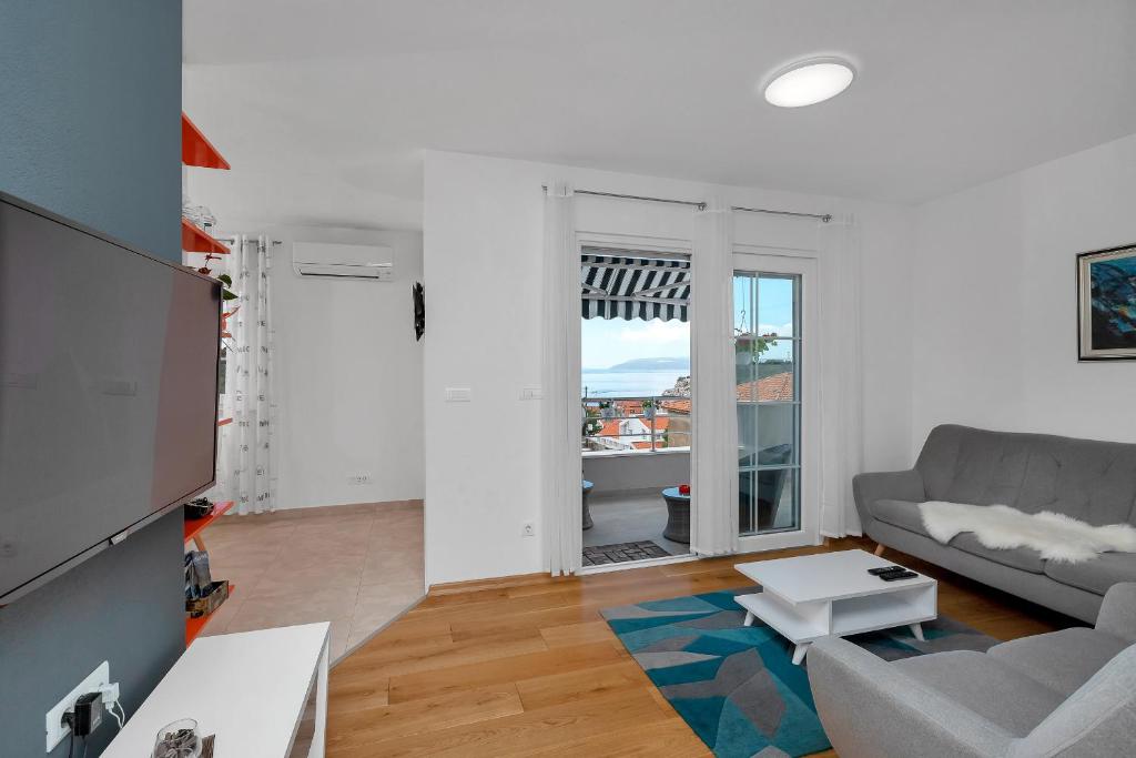 a living room with a couch and a table at Apartman Jug in Makarska