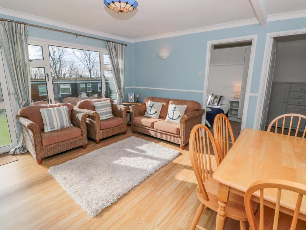 a living room with a table and chairs at The Borrowers in Dartmouth