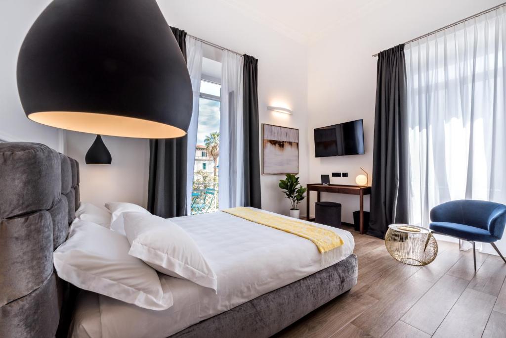 a bedroom with a bed and a large window at La Spezia by The First - Luxury Rooms & Suites in La Spezia