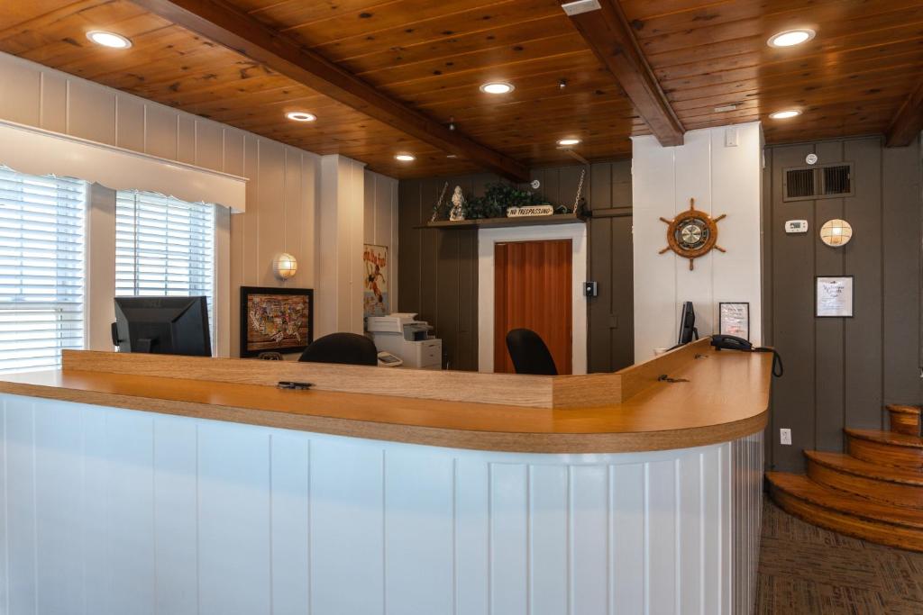 
a kitchen with wooden floors and wooden cabinets at The Admiral Hotel/Motel in Ocean City
