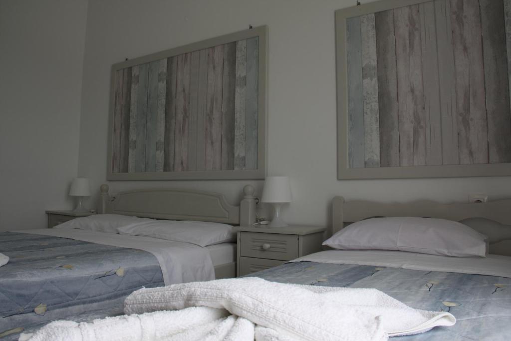 Postel nebo postele na pokoji v ubytování Kalypso Apartments