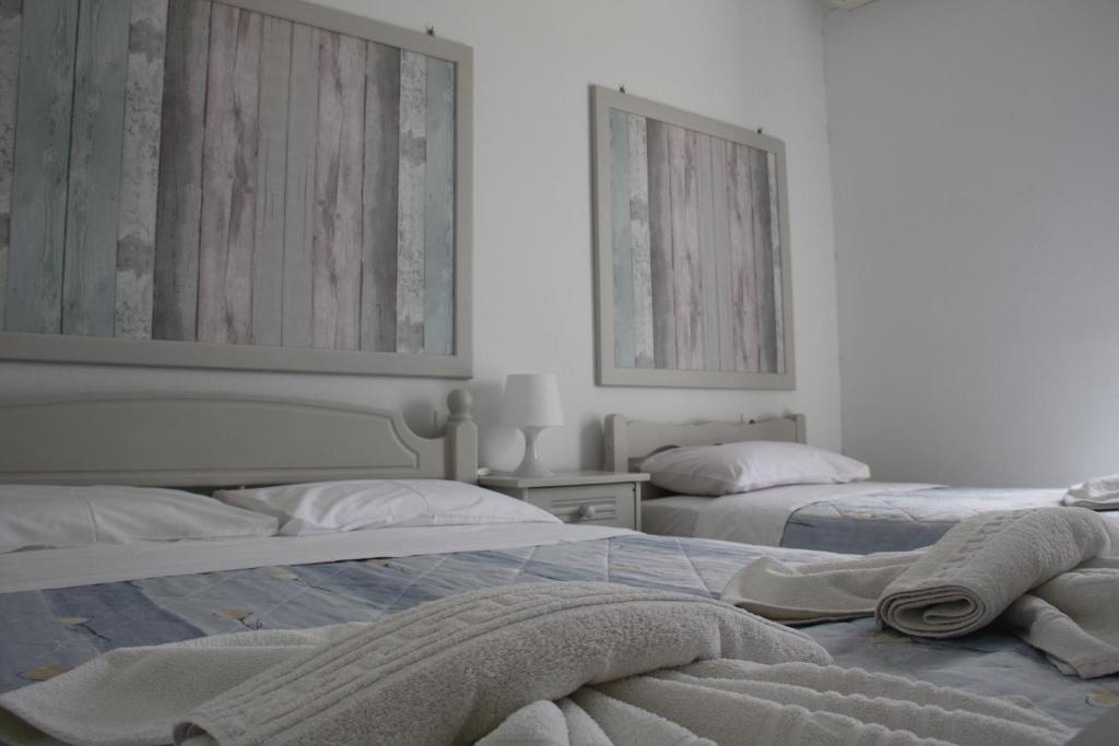 Postel nebo postele na pokoji v ubytování Kalypso Apartments