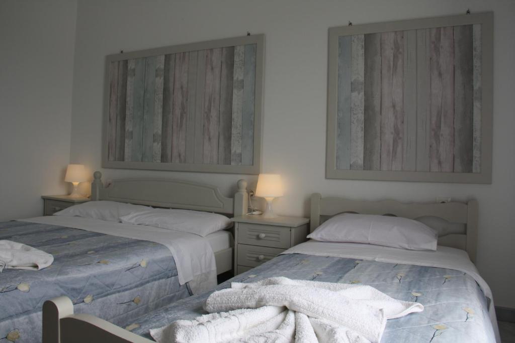 Postel nebo postele na pokoji v ubytování Kalypso Apartments