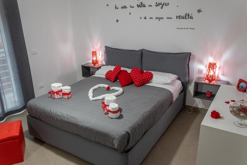 a bedroom with a bed with red hearts on it at Profumi del sud in Cinisi