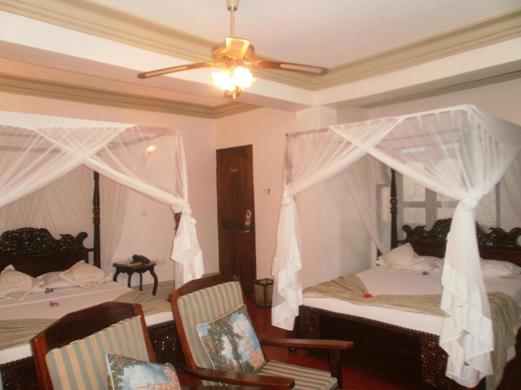 Postel nebo postele na pokoji v ubytování Asmini Palace Hotel