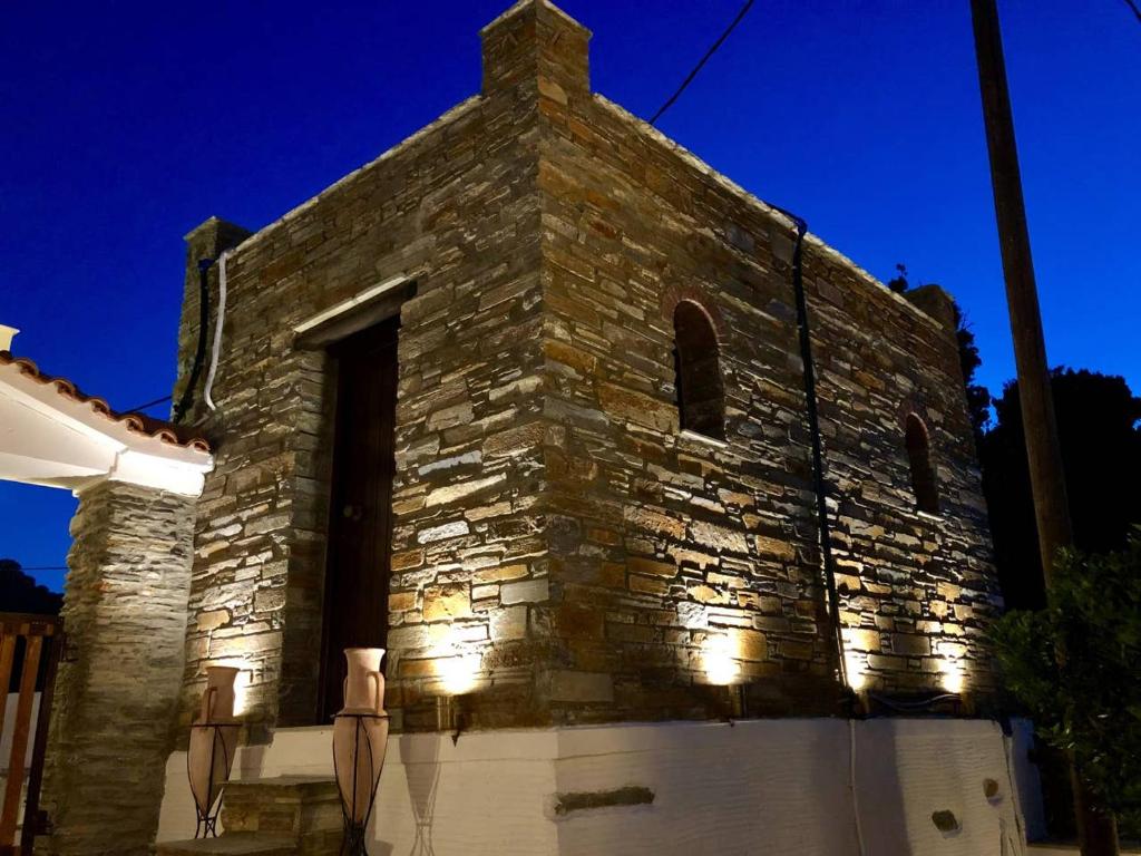 an old stone church at night with lights on it at Relax in a stone build dovecote in Andros