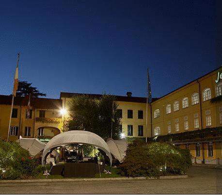 a building with a gazebo in front of it at night at Jet Hotel in Caselle Torinese