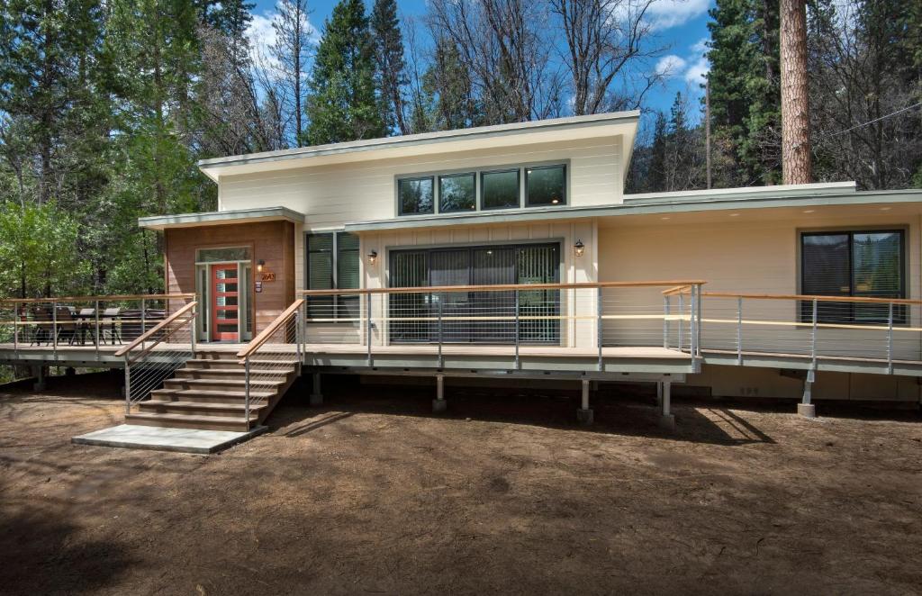 a house with a large front porch and a deck at 11R Spring Meadow Retreat in Wawona