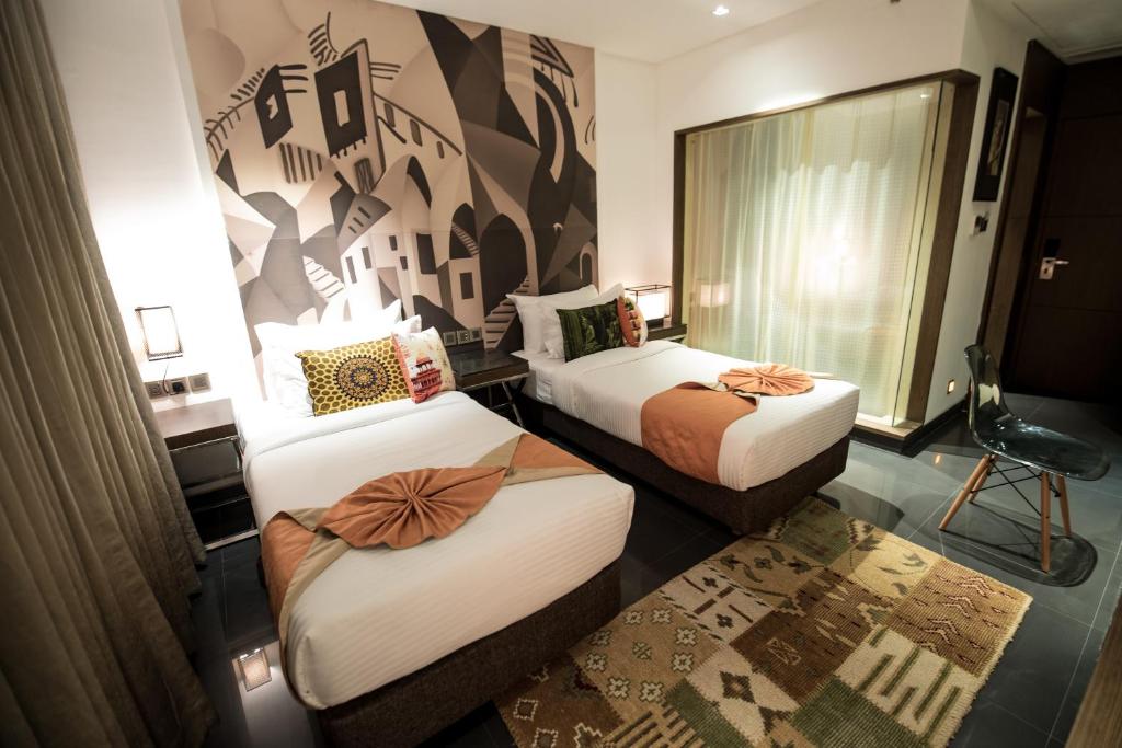 Postel nebo postele na pokoji v ubytování Hotel Gallery 67