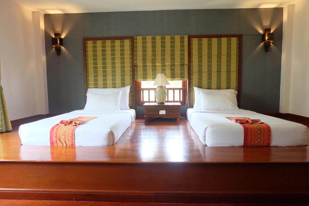 Postel nebo postele na pokoji v ubytování Teak Garden Resort, Chiang Rai