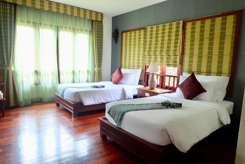 Postel nebo postele na pokoji v ubytování Teak Garden Resort, Chiang Rai