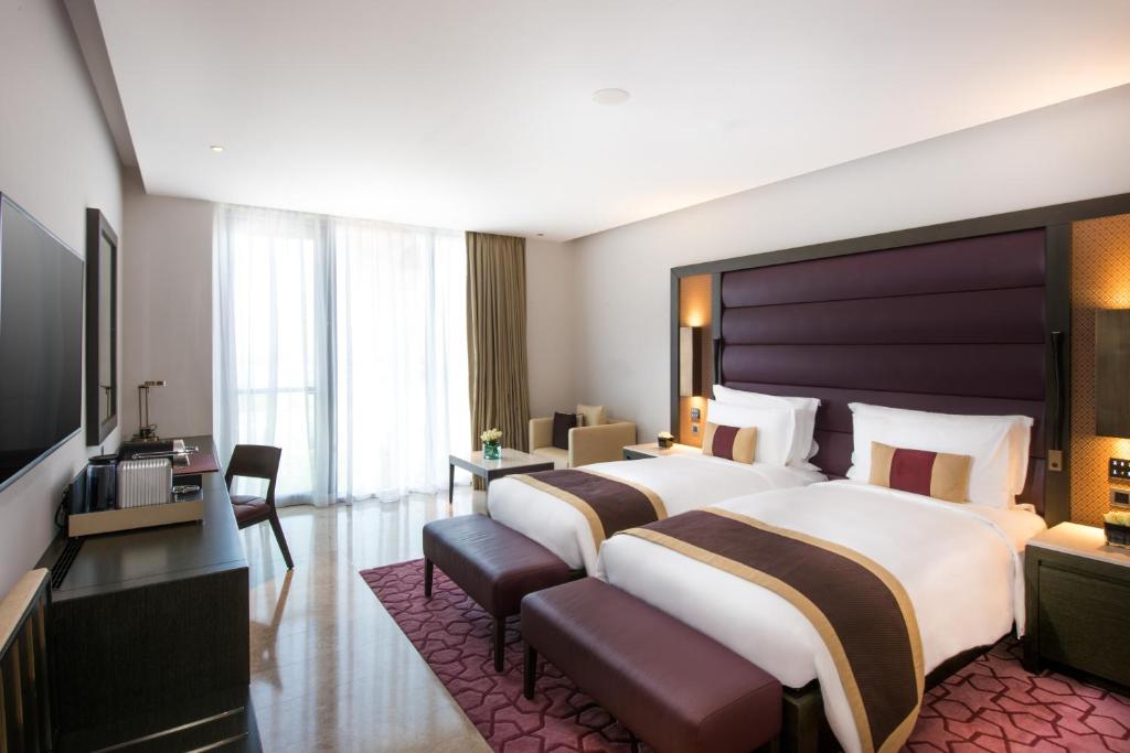 Postel nebo postele na pokoji v ubytování Kempinski Hotel Muscat