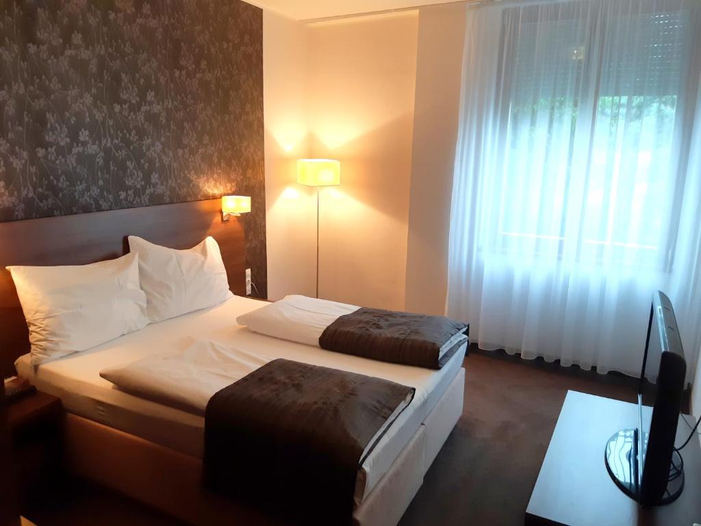Postel nebo postele na pokoji v ubytování Hotel Biograf