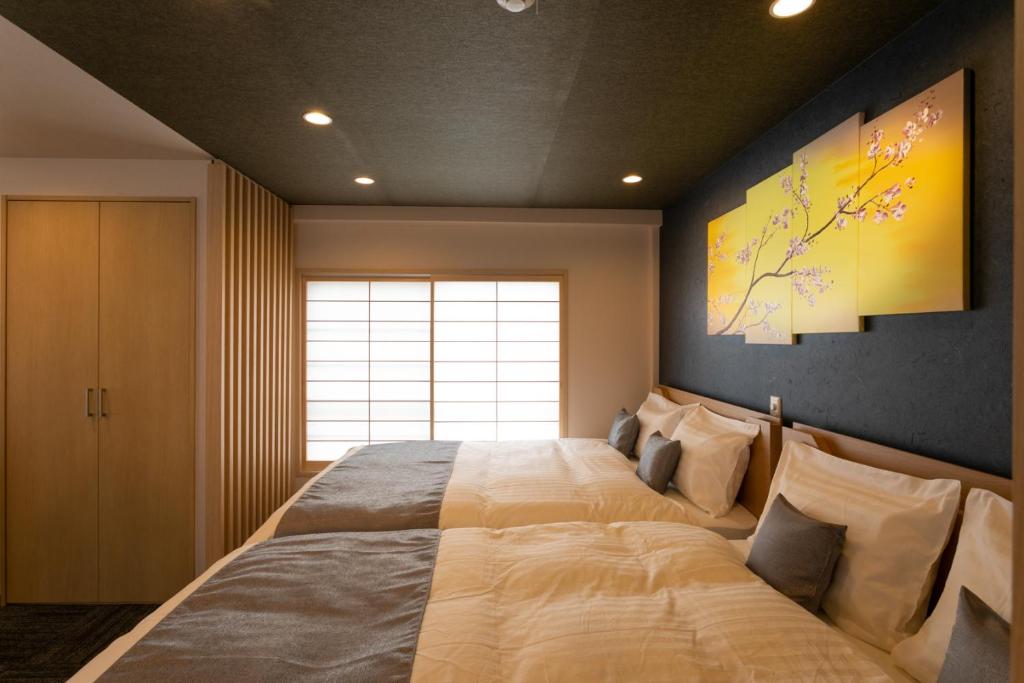 a bedroom with a large bed and a window at Sakura Stay Yoga 301 in Tokyo