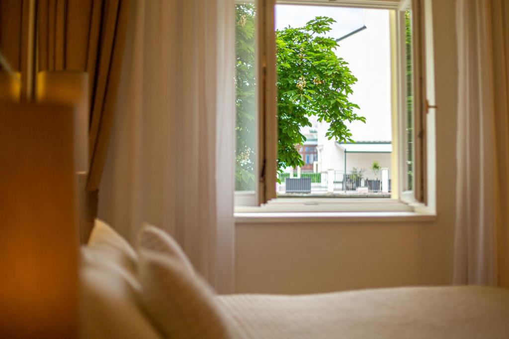 Postel nebo postele na pokoji v ubytování Salvator Boutique Hotel vegan-friendly