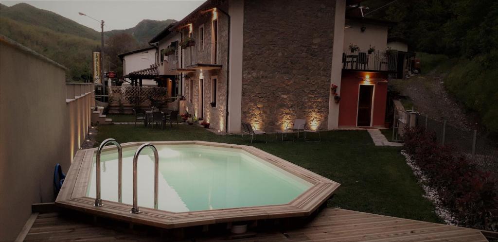 a swimming pool in the yard of a house at B&B da Morena in Gorfigliano
