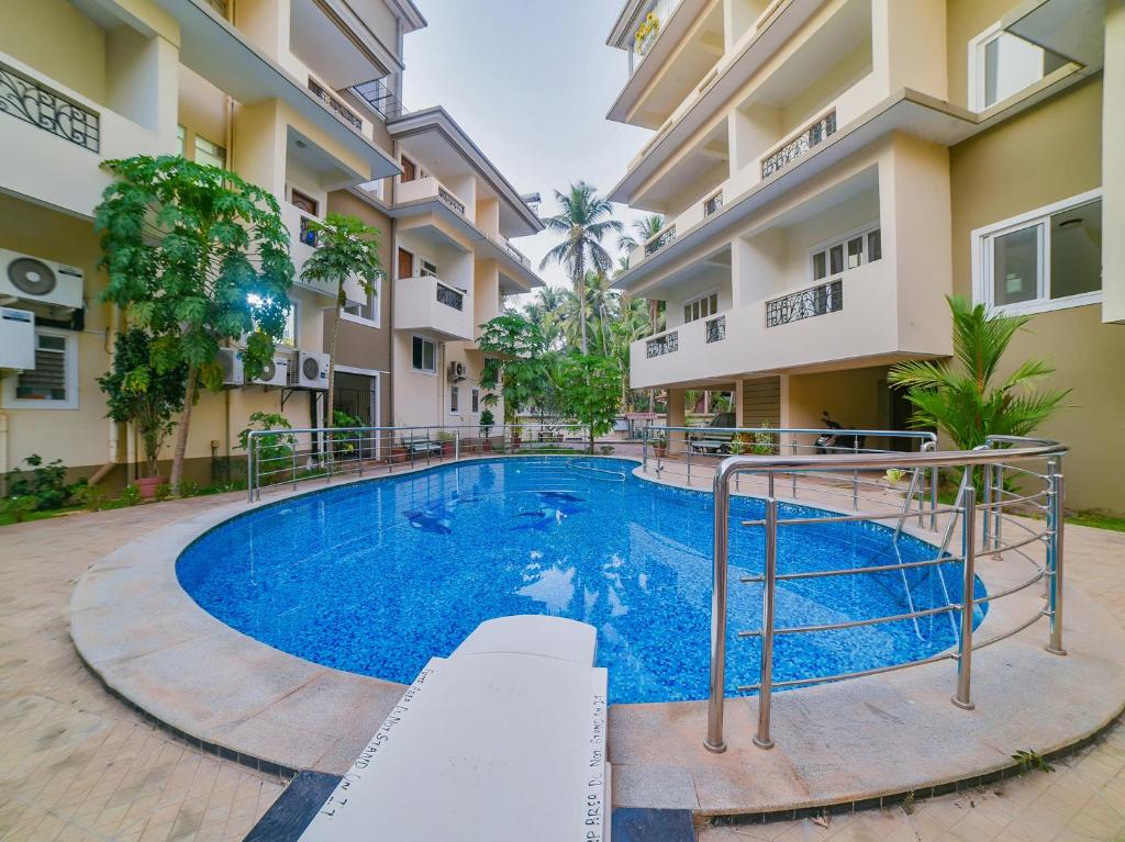 a swimming pool in front of a building at The Avenue Orlim in Cavelossim