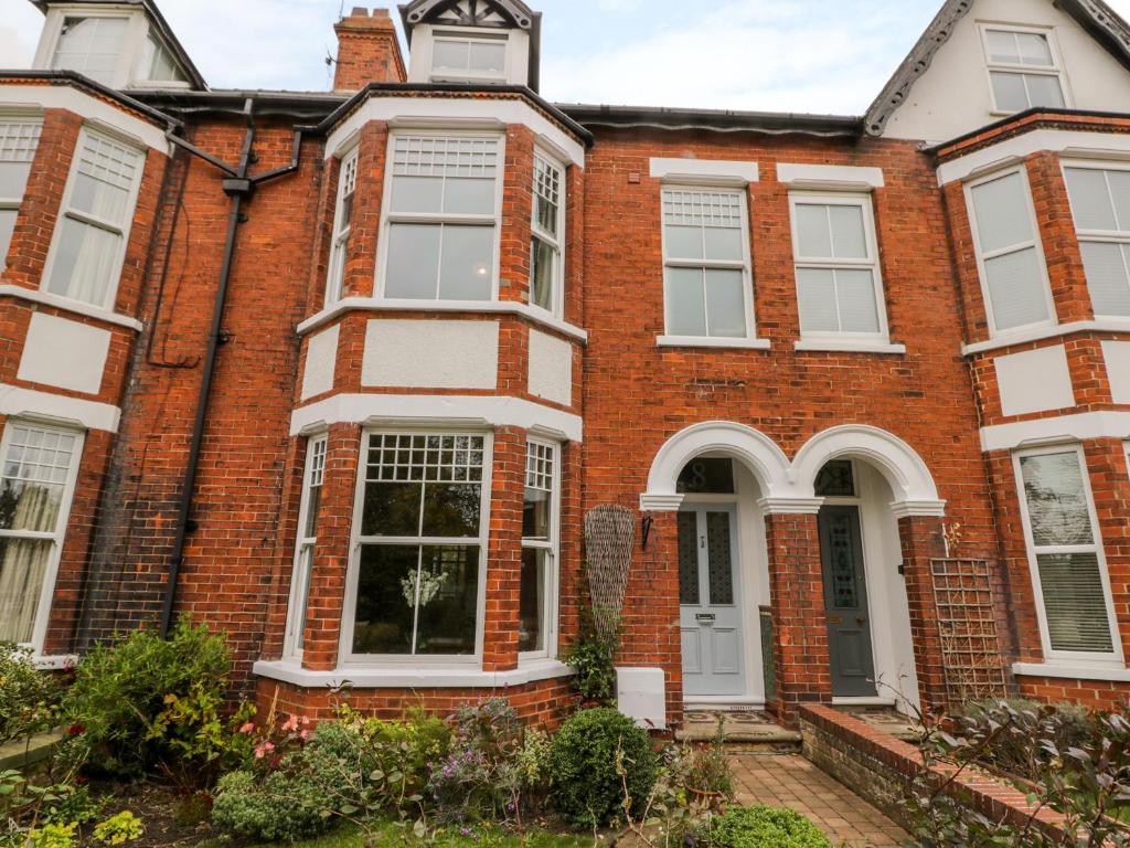 an old brick house with white doors and windows at 8 Wilton Road in Hornsea