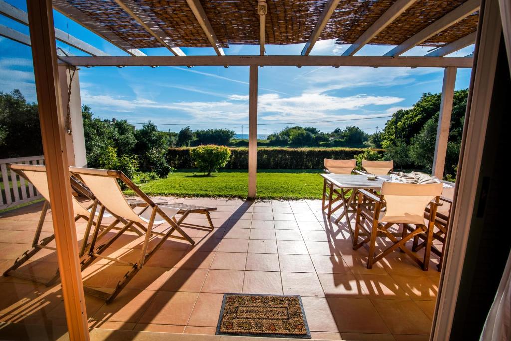 a patio with a table and chairs on it at Nobel Gaea in Preveza