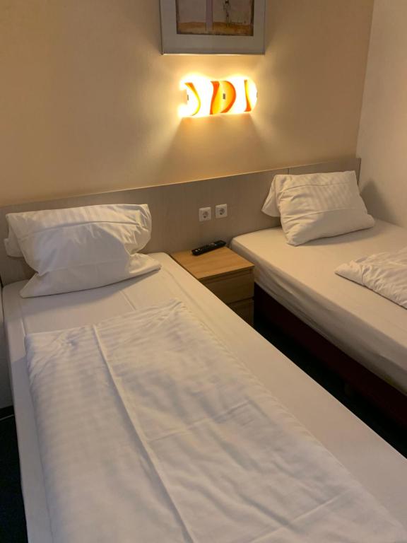 Postel nebo postele na pokoji v ubytování Hotel New Fair Munich Messe