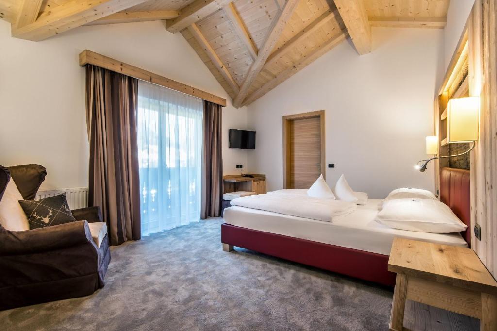 Postel nebo postele na pokoji v ubytování Albergo Posta Pederoa