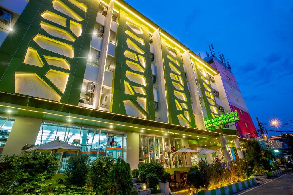 a large building with lights on the side of it at Lucky Green View in Bangkok