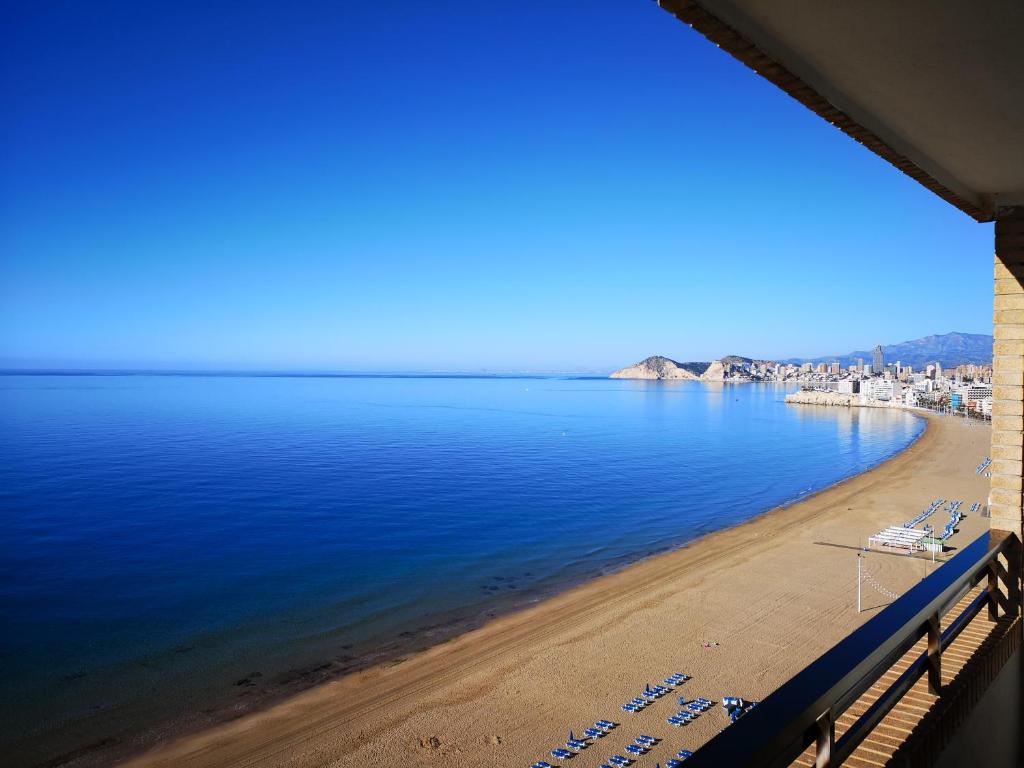 a view of the beach from a balcony at Les Dunes Comodoro in Benidorm