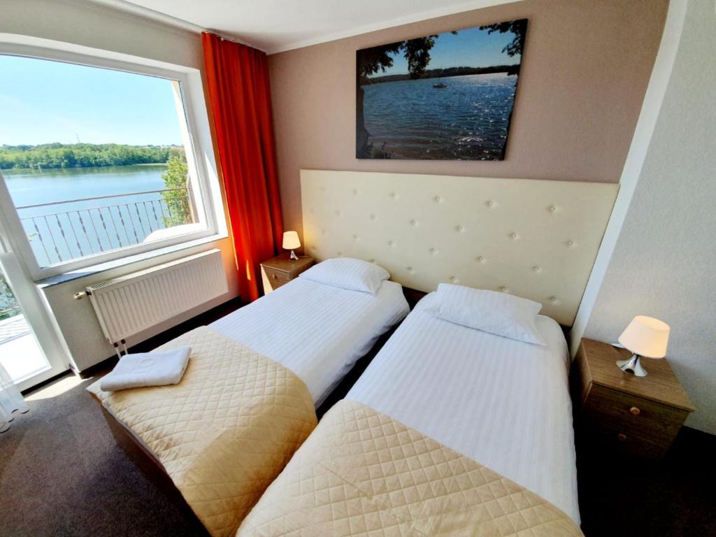 Posteľ alebo postele v izbe v ubytovaní Hotel Mazuria Country & SPA