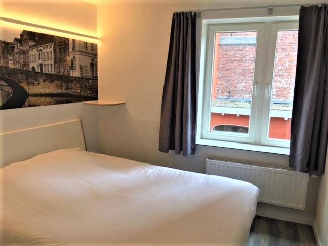 Postel nebo postele na pokoji v ubytování Canalview Hotel Ter Reien