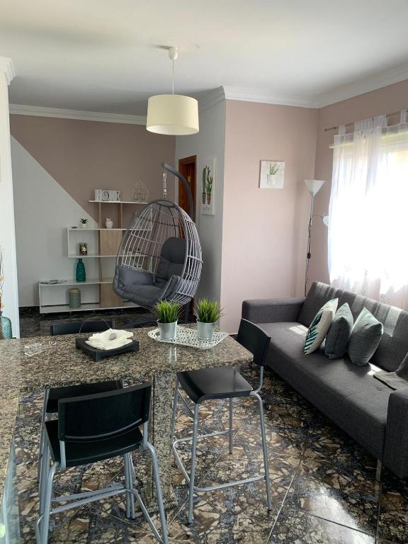 a living room with a couch and a table at Vacacional Tegueste 2ºB in Vecindario