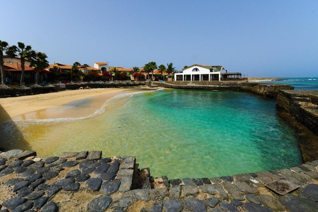 a view of a beach with a house in the water at Porto Antigo Top 10 in Santa Maria