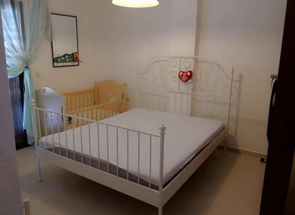 a white crib in a small room with a baby crib at Luxury Sea View Vila 125m2 in Siviri