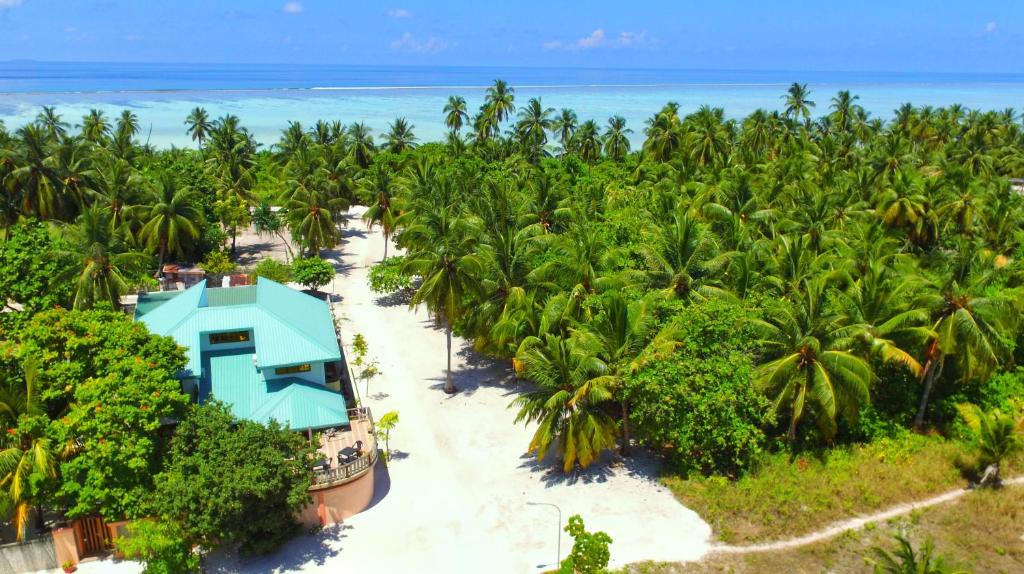 an aerial view of a resort with palm trees and the ocean at Remora Inn in Faafu
