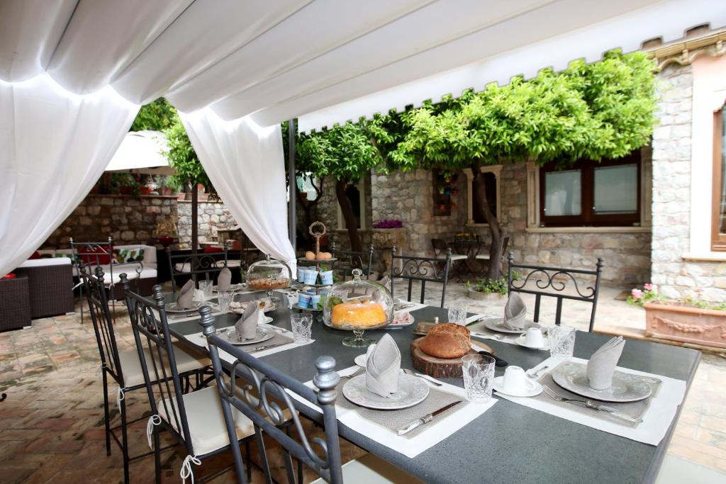 a dining table with chairs and a white tent at Relais 147 - Luxury b&b in Taormina