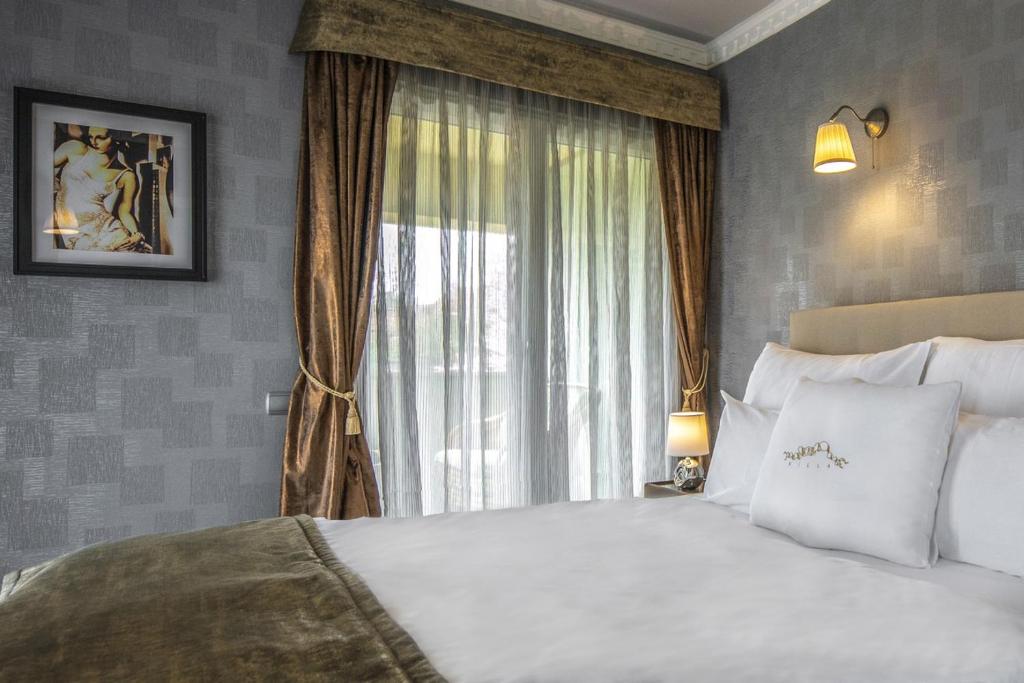 Postel nebo postele na pokoji v ubytování Erla Villa Boutique Hotel