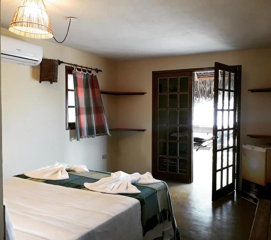 Postel nebo postele na pokoji v ubytování Pousada Doze Cabanas