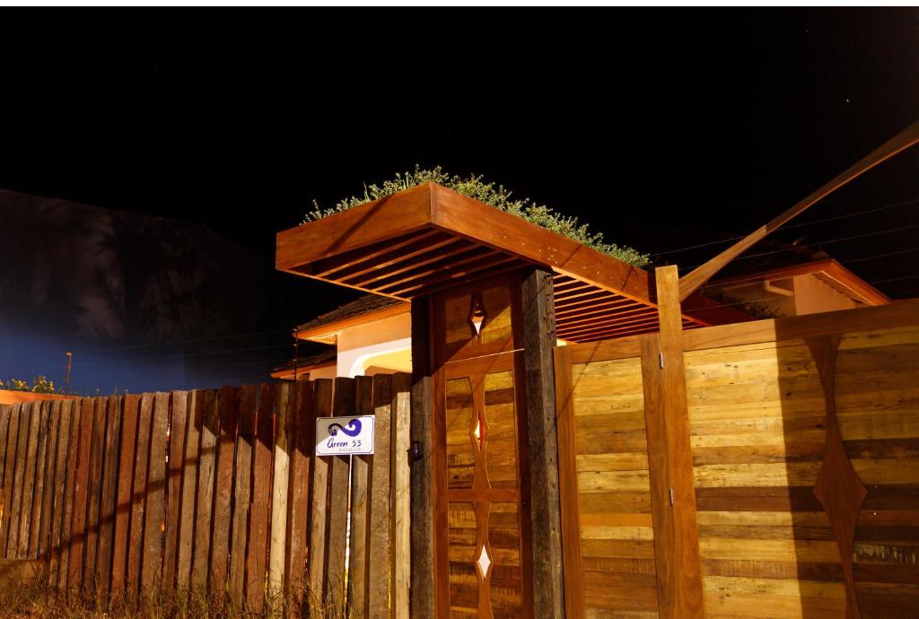 a wooden fence with a plant on top of it at Green 53 Boutique Hotel in Ilhéus
