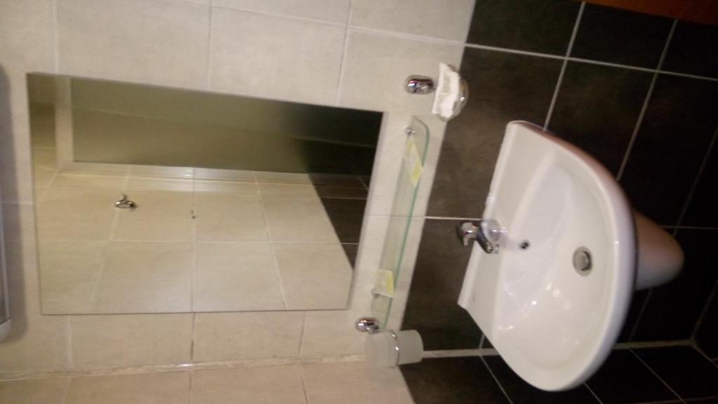 A bathroom at Apartment in Complex TARA