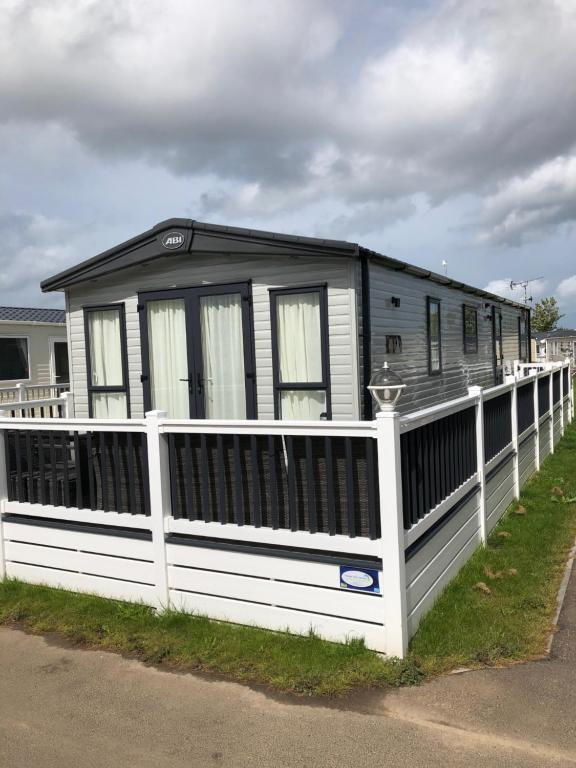 a black and white house with a white fence at Kent Getaways in Westgate-on-Sea