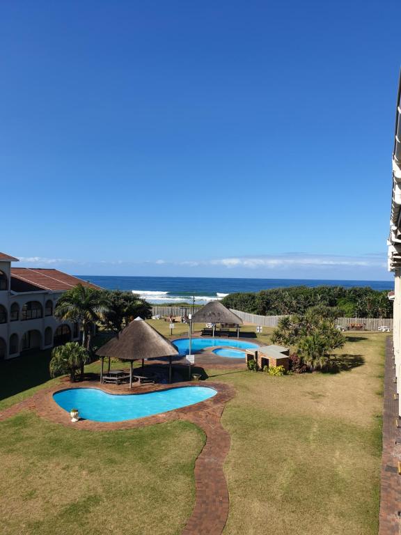 a view of one of the pools at the resort at Cabana Del Mar 69 in Amanzimtoti