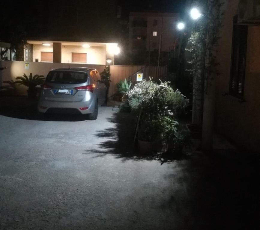 a car parked in a parking lot at night at La Casa sul Viale in Siracusa