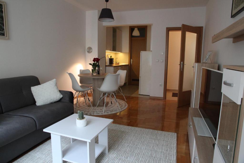 ein Wohnzimmer mit einem Sofa und einem Tisch in der Unterkunft Vana apartment Zagreb in Zagreb