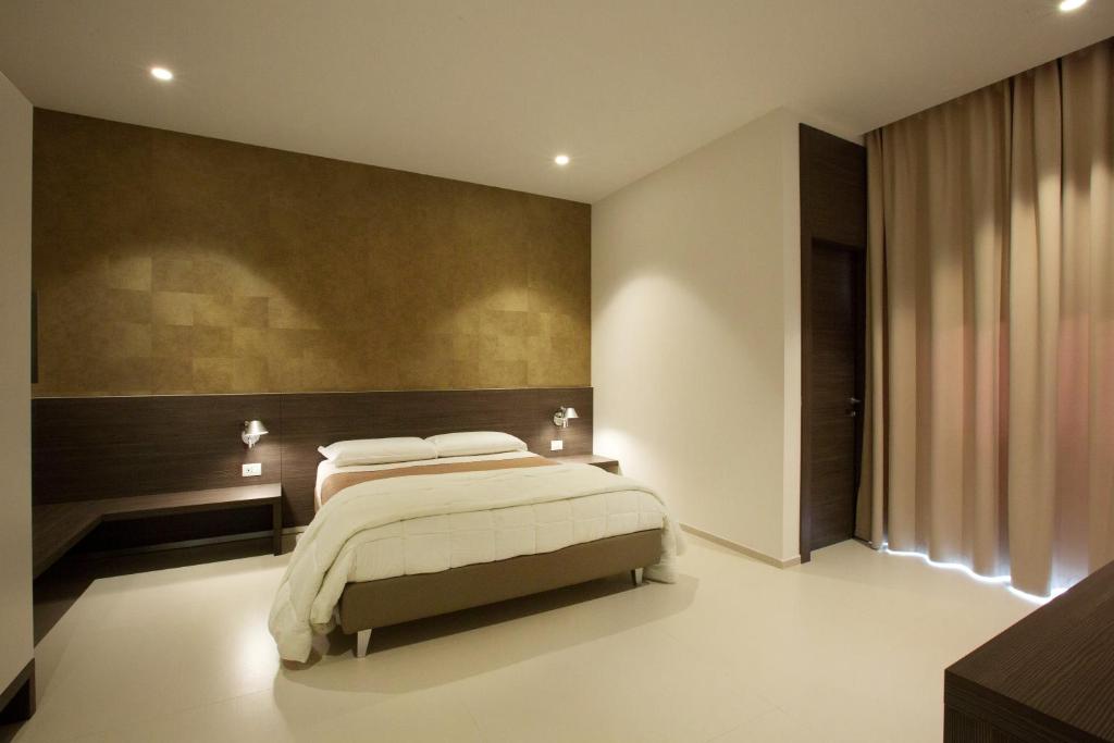 Postel nebo postele na pokoji v ubytování Hotel New Bari