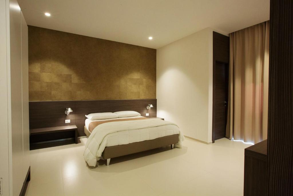 Postel nebo postele na pokoji v ubytování Hotel New Bari