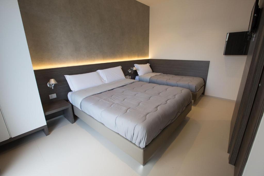 Postel nebo postele na pokoji v ubytování Hotel New Bari