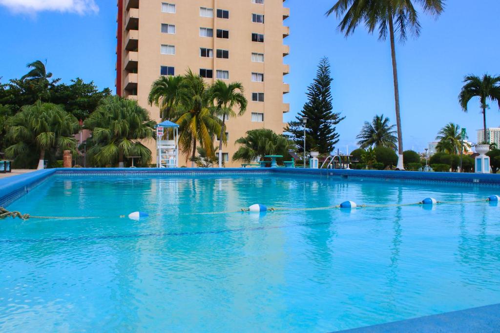 a large swimming pool with birds in the water at Sand Dreams at Turtle Towers in Ocho Rios